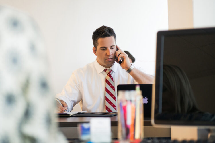 attorney at his desk on a phone call.